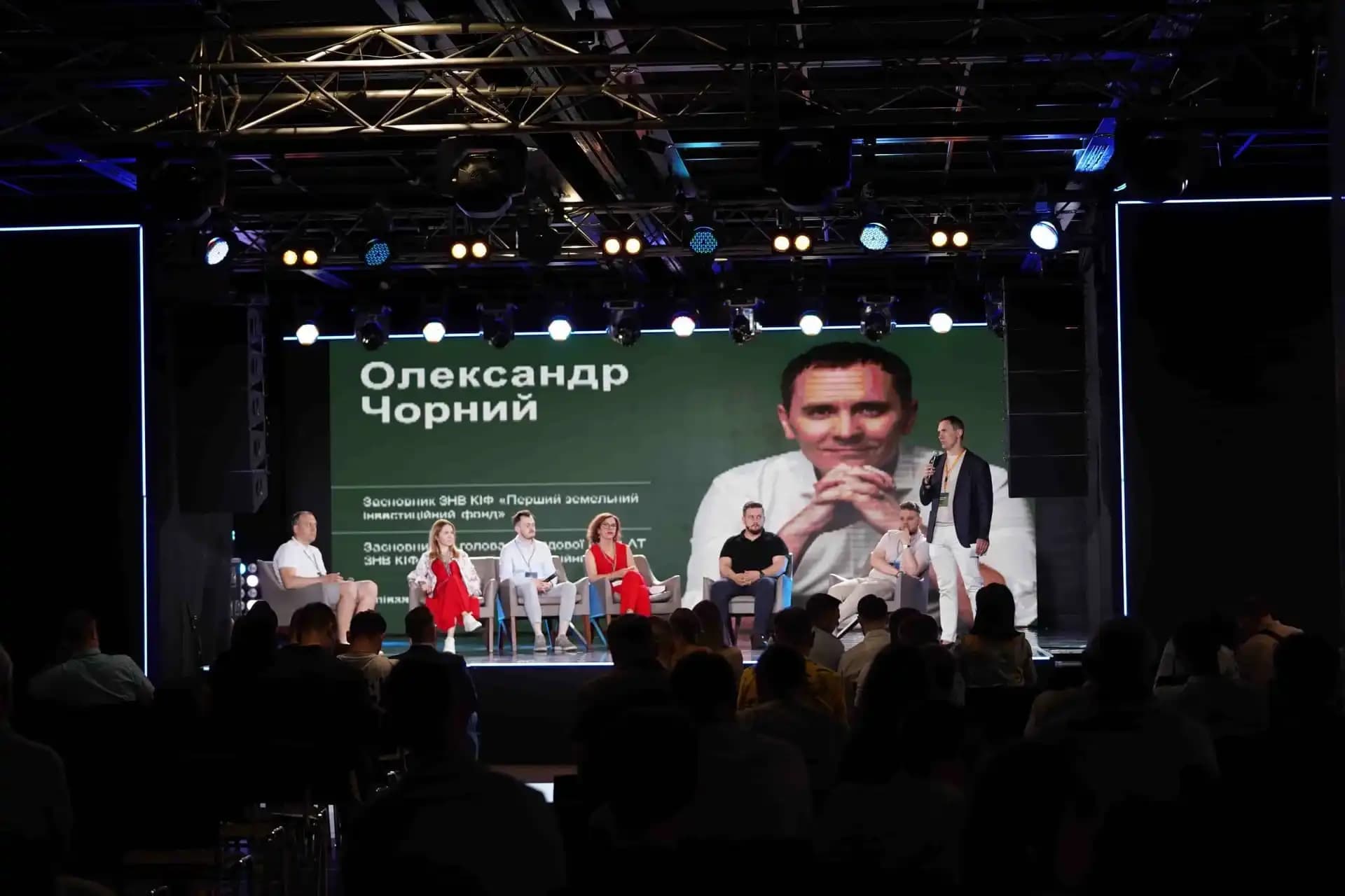 Panel discussion featuring multiple speakers on stage.